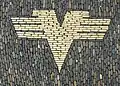 Former logo of the Volksbanken, displayed on a pavement in Freiburg im Breisgau