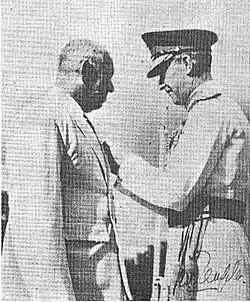 Mr. W. E. Perera receiving his insignia of the order of the M.B.E. from General Sir Gerald Templer, the High Commissioner of the Federation of Malaya.