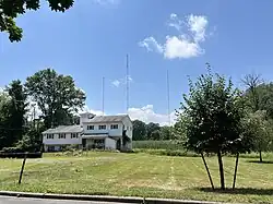 WGHT (former WKER) studio building in Pompton Lakes, New Jersey - with transmitter towers in background
