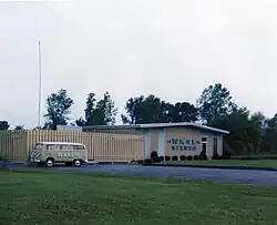 The combined WKAL studio and transmitter facility, South Jay Street, Rome, New York; Spring of 1974. During the previous year, FM Stereo service had been initiated, simulcasting AM programming. The station's building markings were updated to advertise the change. To the left the station's VW Bus can be seen which was utilized during this period for promotional events.
