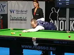 John Higgins playing a shot