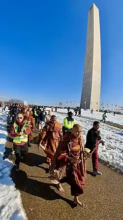 Venerable Bhikkhu Paññākāra walking by the Washington Monument