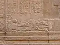 (Close-up below columns of hieroglyphs) Prisoner-tied-to-Stake