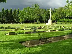 Image 47Chittagong War Cemetery is a Commonwealth War Graves Commission cemetery located at Dampara 22 kilometers north of the airport and 8 kilometers from the port. The burial area is surrounded by a large plantation. A tarmac lane leads from the entrance gate to the burial area which is entered through a metal gate flanked by two small brick chapels. Photo Credit: Hossain Toufique Iftekher