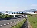 crosses the RD884 near Farges (the daily municipal waste train is seen, heading for Bellegarde)