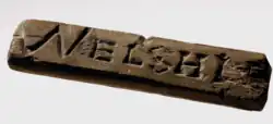 Wooden object engraved with "WELSHLE"