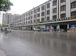 Residential buildings on both sides of the street.