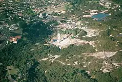 Aerial view of Whakarewarewa; Pōhutu Geyser is erupting.