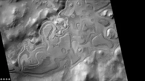 Layers just outside rim of western side of South crater in the form of "Swiss cheese", as seen by CTX camera (on Mars Reconnaissance Orbiter). Note: this is an enlargement of a previous image of west side of South crater.