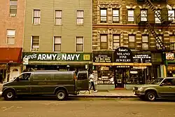 A photo of a street in South Williamsburg. Several businesses can be seen including Cato's Army and Navy and Robert's Milano Fine Jewelry