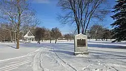 A colour photograph of a park, covered in snow