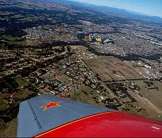 Aerial view from the north-west, Hume Freeway bypass somewhere around top, One and Three Mile creeks meeting around the middle.
