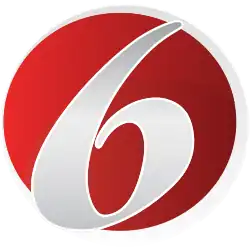 A red circle trimmed in white containing an angled serif numeral 6.