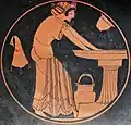Kalē woman bathing at the laver, with a water bucket, a skyphos, and a wineskin, c. 500 BC