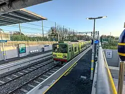 DART train (8600 Class) paused at the Northbound platform at Woodbrook station.