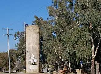 Rest area at Wunghnu showing the mural on the water tower