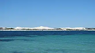 Vehicles on Le Grand Beach, seen from Wylie Bay
