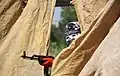 YDG-H member peaking from behind a curtain.