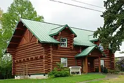 The exterior of a log cabin housing the Yamhill County Museum.