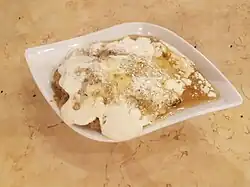 Masoob, made of bananas, ground flatbread, cream, cheese, honey, and sometimes dates
