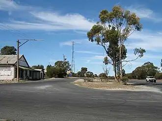 Main Street of Yumali - old General Store, Yumali Garage, payphone & Telstra tower