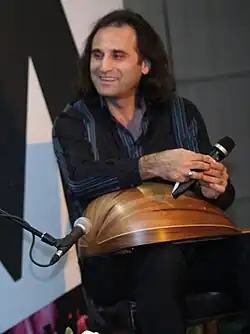 Yurdal Tokcan on stage with Burcu Karadağ and Göksel Baktagir during a performance in Istanbul in 2012.