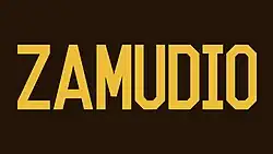 the word "ZAMUDIO" in gold lettering on a brown background