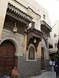 Decorated doorways on the north side of the zawiya, near the minaret