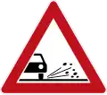 Sign 101-52 Grit/gravel at the edge of the road