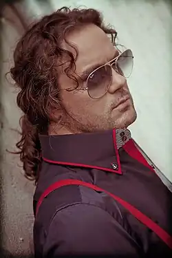 Serbian singer Željko Šašić wearing sunglasses in a portrait photograph.