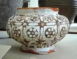 Earthenware bowl decorated with a slip and inlaid with glass paste. 4th-3rd century BCE. British Museum