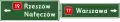 E-2b "signpost board placed above the carriageway"