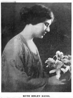A white woman with dark hair, photographed in profile