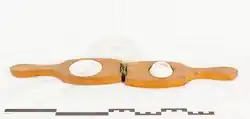 Old garlic press made of wood and ceramic.