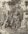 Statue of four-armed goddess with child.