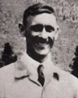 Blurred, half-length portrait of a smiling man, standing with his hands on his hips