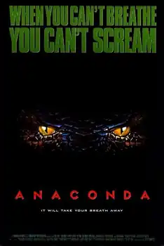 The eyes of a snake are seen on a dark background.