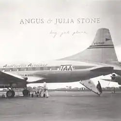 A black and white image of a Trans Australia Airlines Convair 240 parked on the airport apron with its rear airstair opened.