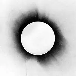 A photo of a solar eclipse with the colours inverted