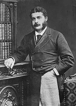 youngish white man with dark hair, side whiskers and small moustache