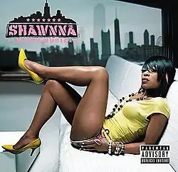 The cover features Shawnna posing on a white sofa, wearing a yellow shirt, brown shorts and yellow heels, with the Chicago skyline behind her. Both the artist's name and the album title appear on the top left corner, colored in pink.