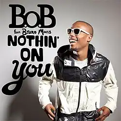 A picture of B.o.B standing up on the left of the image laughing, with the words "B.o.B feat. Bruno Mars Nothin' on You" with capital font on the right of B.o.B