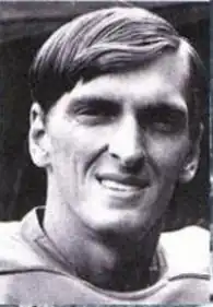 Black-and-white head shot of Hughes smiling