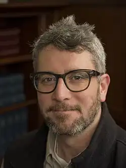 Portrait of Brangwynne in a library.
