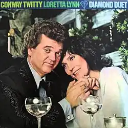 photo of Conway Twitty and Loretta Lynn with dinner glasses