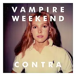 Surrounded by a white border, a photo of a blonde woman facing the camera, wearing a white polo shirt. Above reads "VAMPIRE WEEKEND" and below reads "CONTRA".