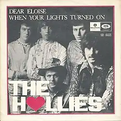 The Swedish cover of the Hollies' 1967 single "Dear Eloise", with "Wehn Your Lights Turned On" on the B-side. It is a framed photograph of the Hollies, depicting (from left to right) members Allan Clarke, Tony Hicks, Bobby Elliott, Bernie Calvert and Graham Nash