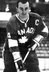 Black and white photo of an adult male in a hockey uniform