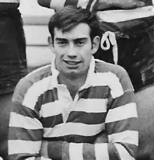 b/w image of a caucasian male, twenties, with short hair wearing a striped rugby shirt