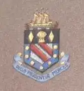 Arms of District Bank bearing the Latin motto Decus Prudentiæ Merces, meaning "honour is the reward of prudence."